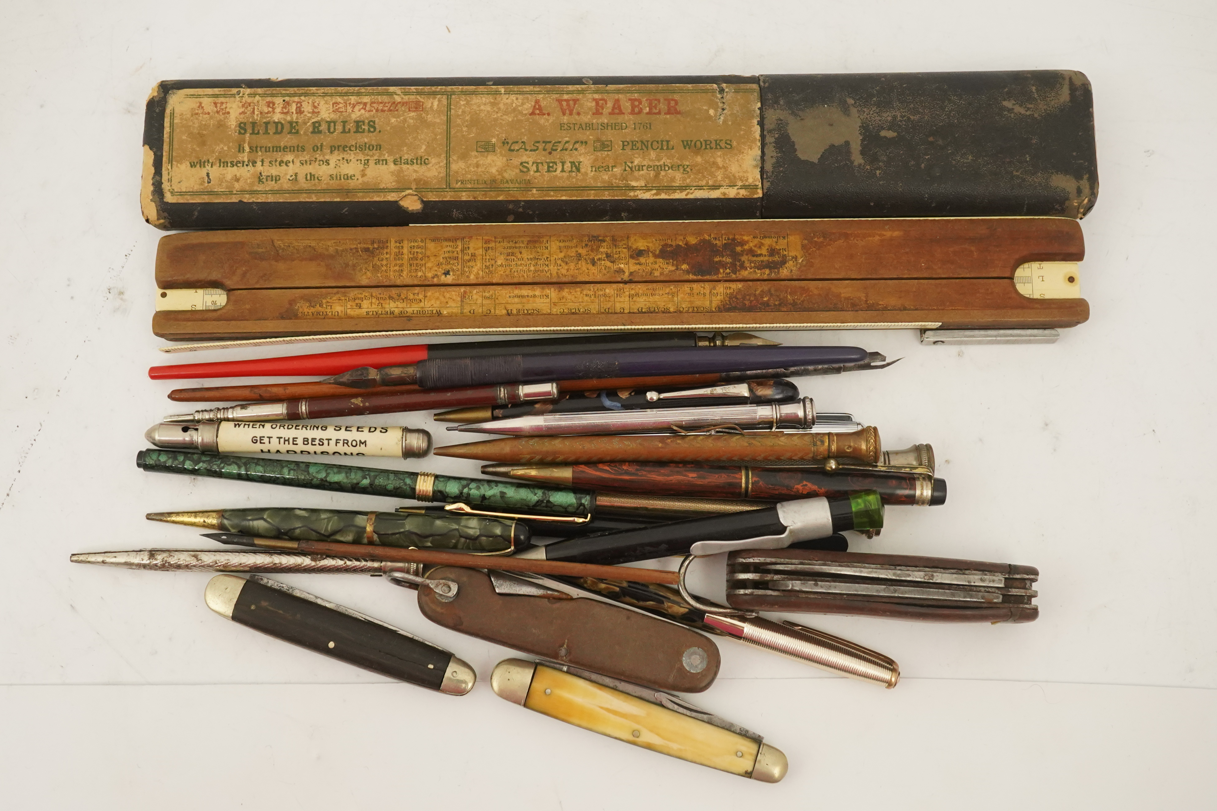 A collection of pens, etc. from 1950's and later and a collection of propelling pencils from 1930's and later, four penknives and a slide rule